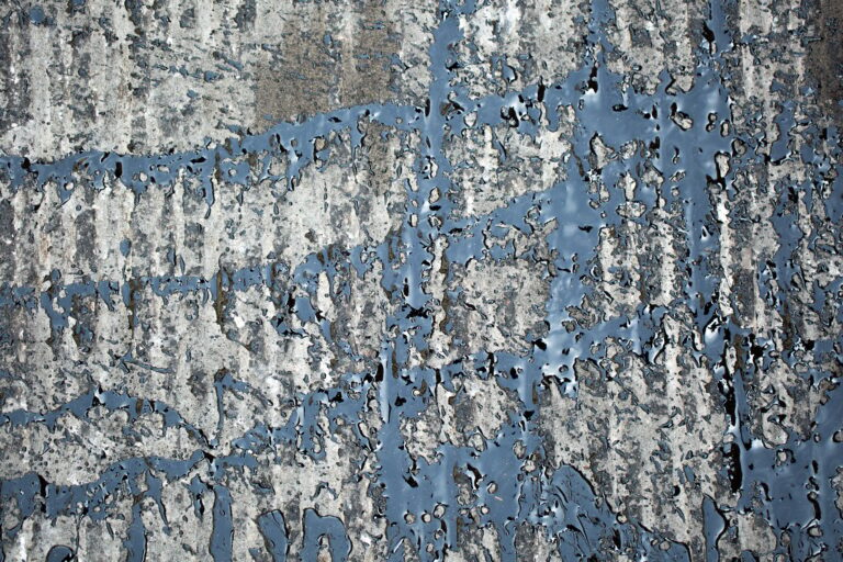 Abstract bitumen flows in graffiti style on asphalt