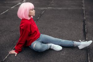 Asian teenager relaxing on asphalt
