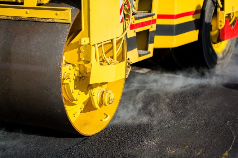 Compact steamroller flatten out the asphalt