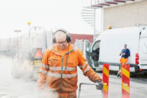 Manual worker laying asphalt at construction site