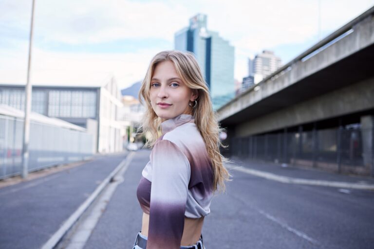 Portrait of gen z city girl, natural beauty and standing on asphalt road with confidence, woman emp