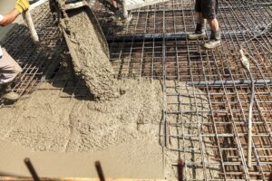 Pouring concrete into the construction of the house. Builders are pouring ready-mixed concrete