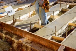 pouring concrete pavement Spreading concrete for sidewalk repair
