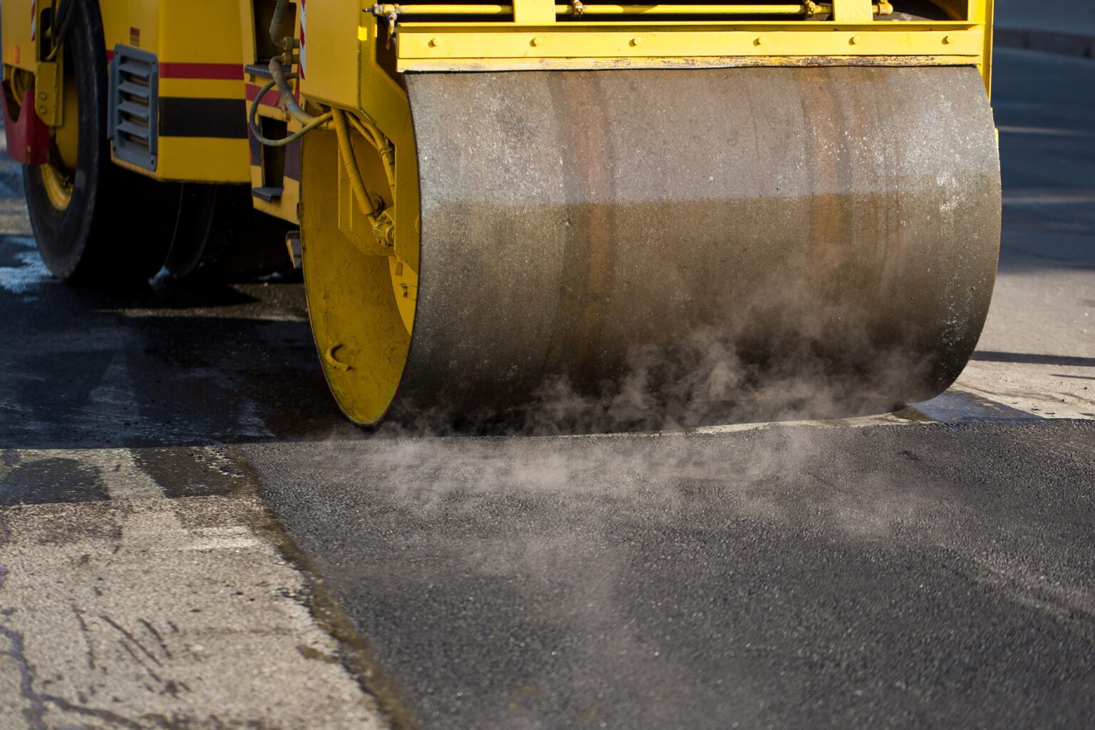 Road roller compacting asphalt