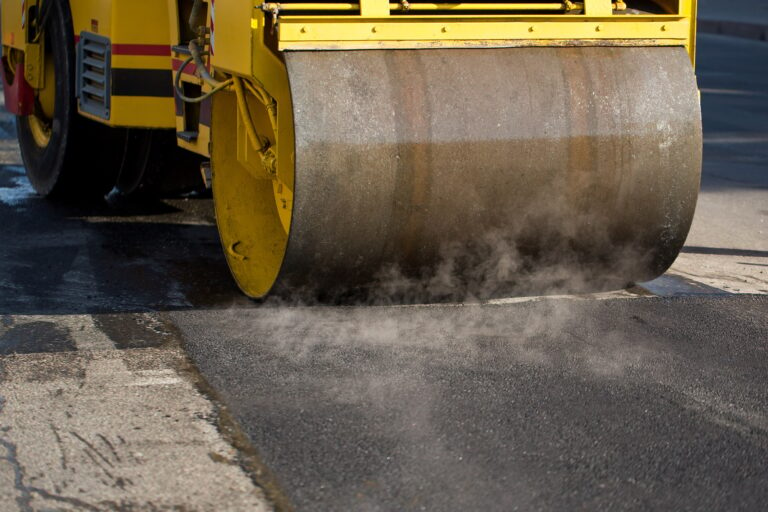 Road roller compacting asphalt