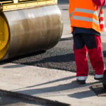 Road roller compacting asphalt