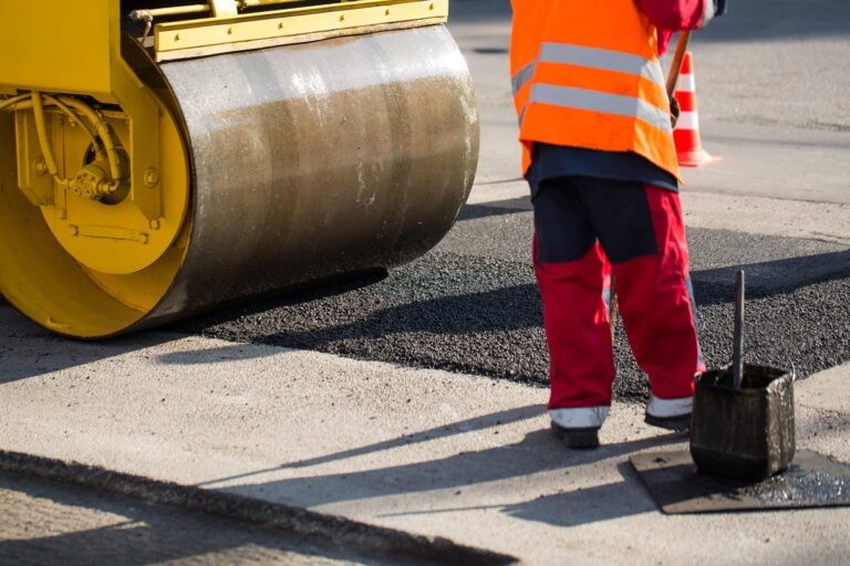 Road roller compacting asphalt