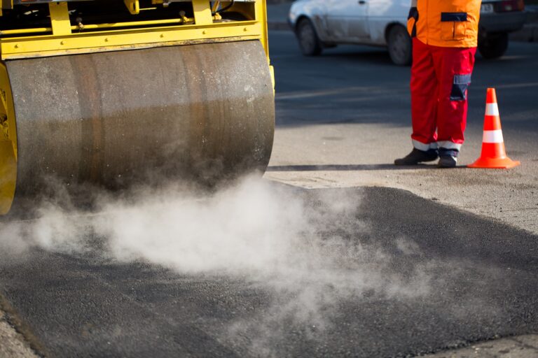 Road roller compacting asphalt