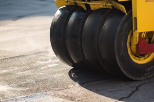 Road roller compacting asphalt