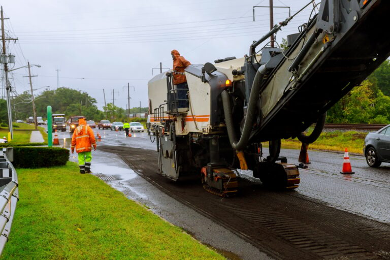 Road works asphalt removing machine loading powdered asphalt on the truck