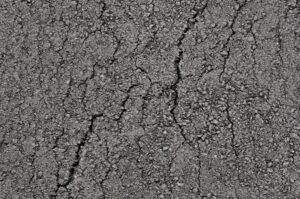 Surface of new clean cracked asphalt. Top view.