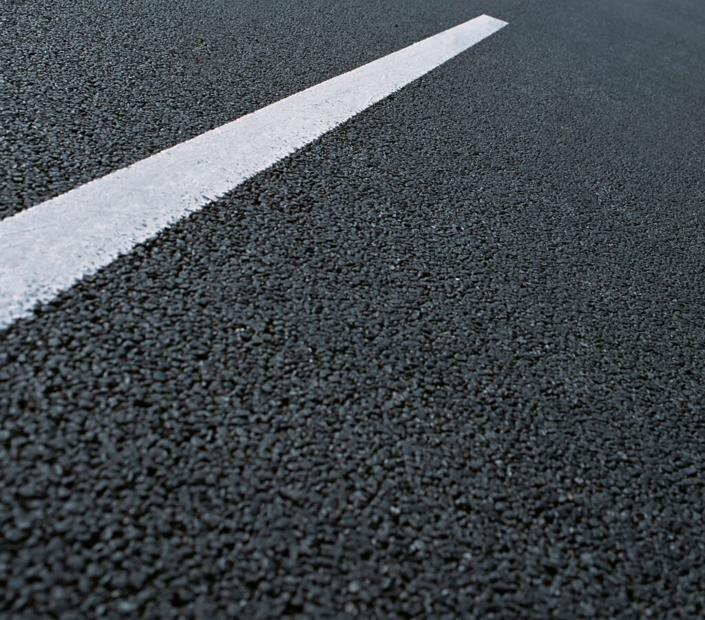 White dotted line on city asphalt road background