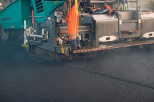 Asphalt paving. Paver machine and workers. New road construction.
