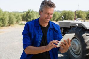 Worker using digital tablet on road on a sunny day