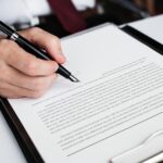 Hand signing business contract