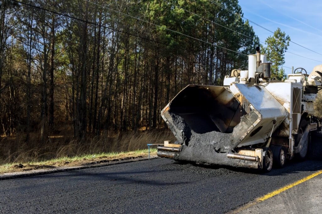 Industrial machinery working with asphal industrial laying fresh asphalt