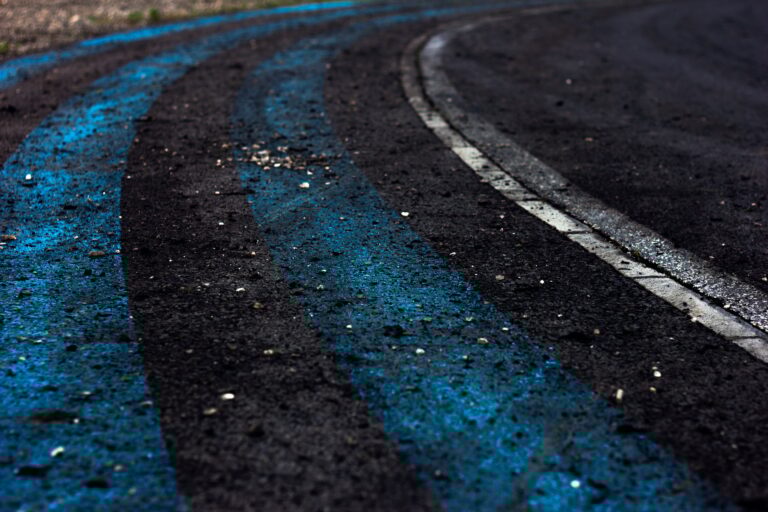 Motor racing track corner apex. Tire tracks on asphalt